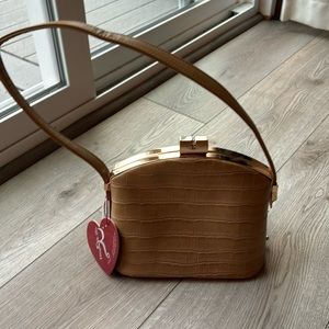 Tan bag with gold clasp.